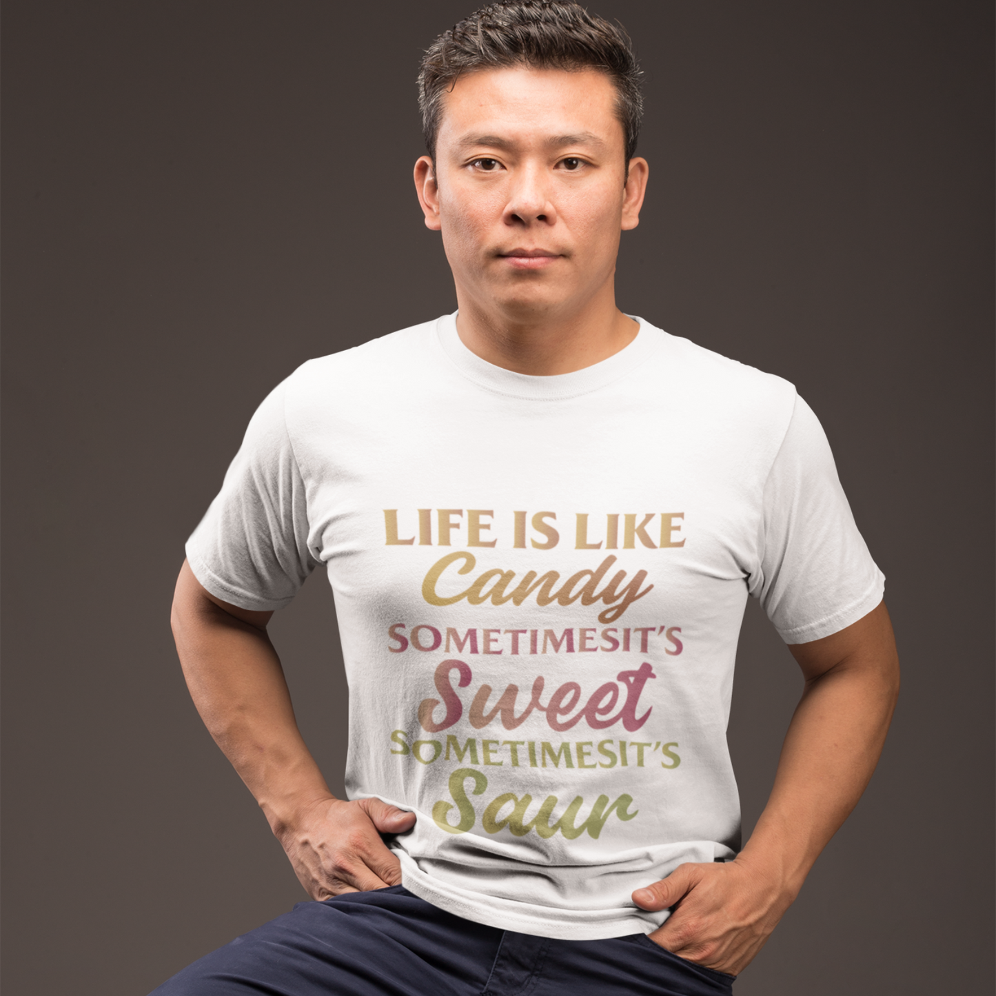 Man wearing a white t-shirt with a colorful text design on a dark background