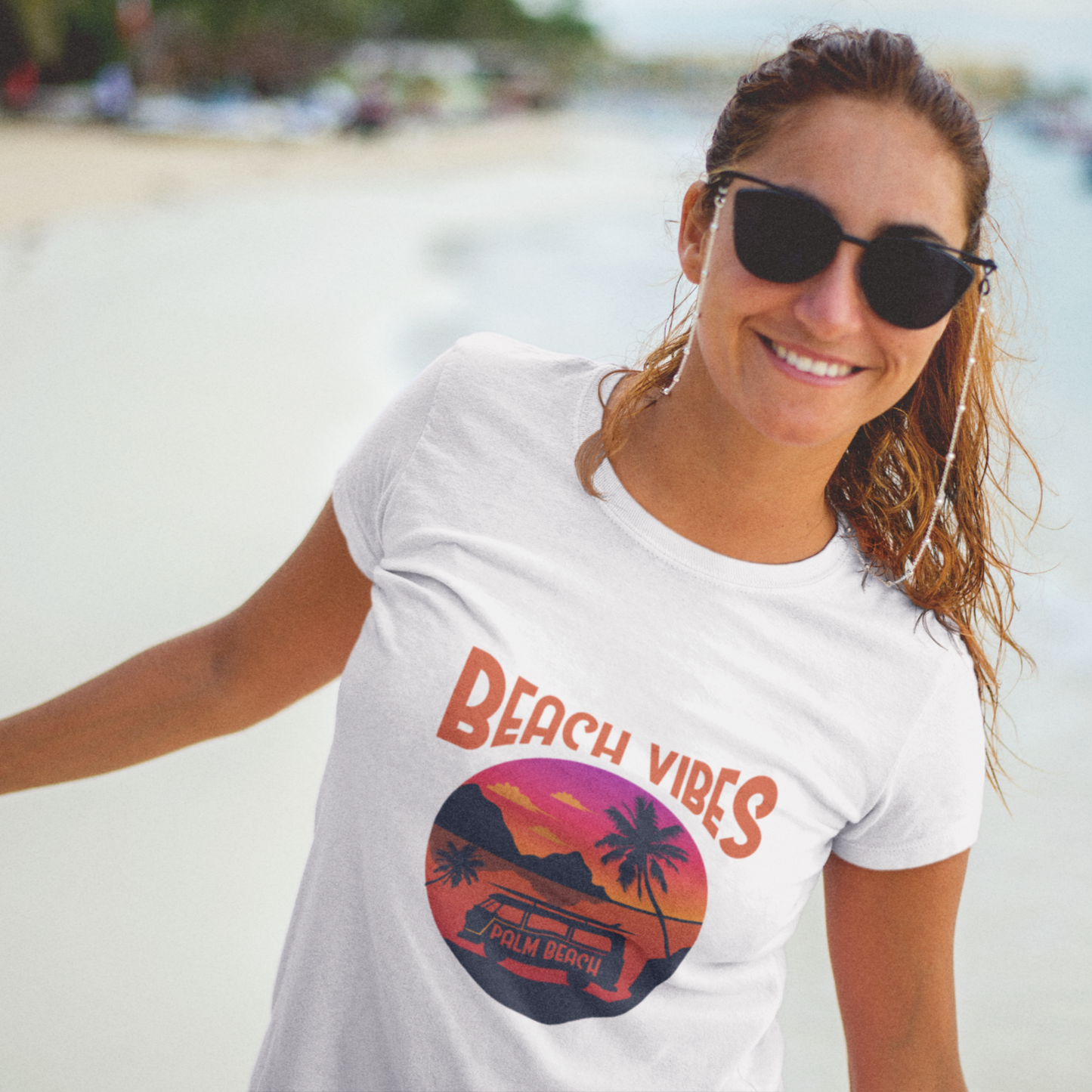 Woman wearing a 'Beach Vibes' t-shirt on a beach