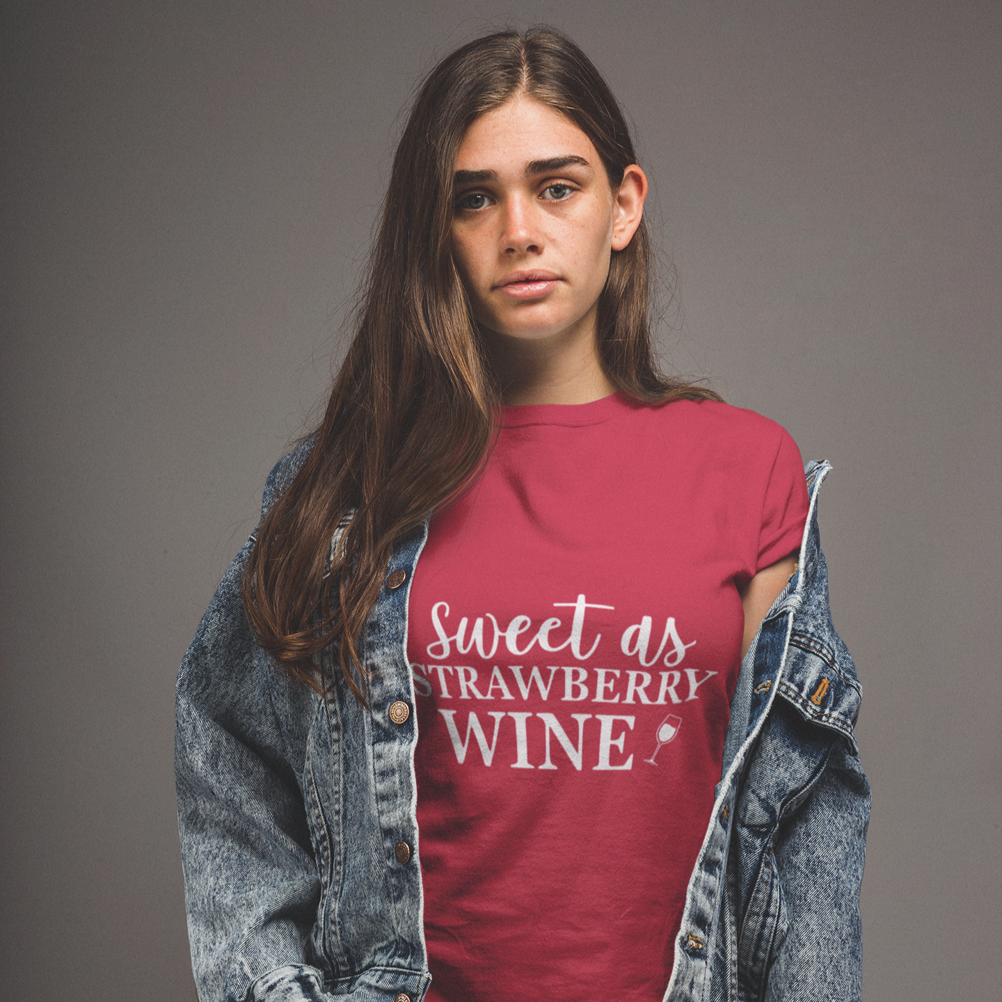Person wearing a red t-shirt with 'Sweet as Strawberry Wine' text, standing against a gray background