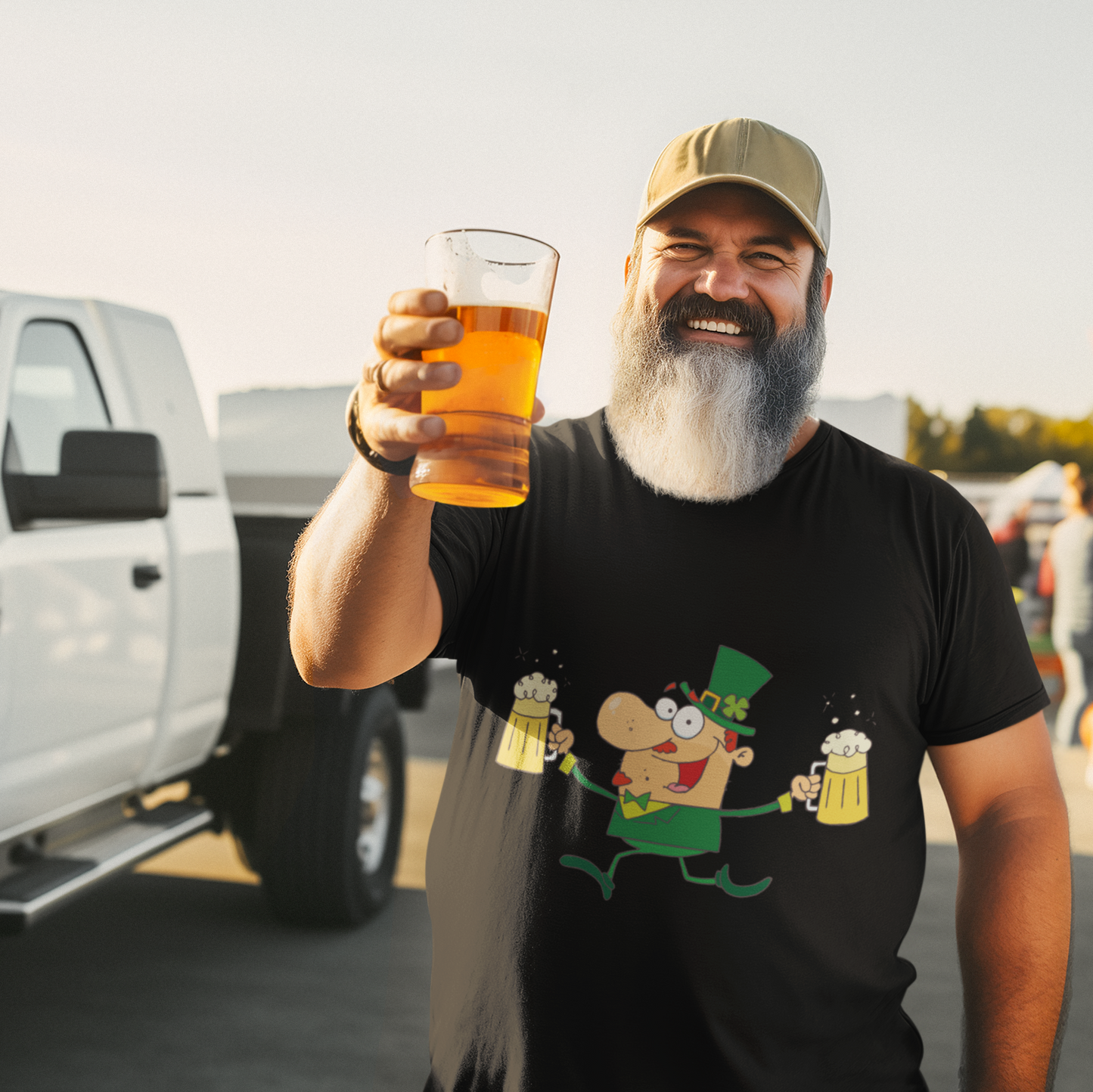 Man holding a beer and a pint glass in a parking lot with people and vehicles in the background.