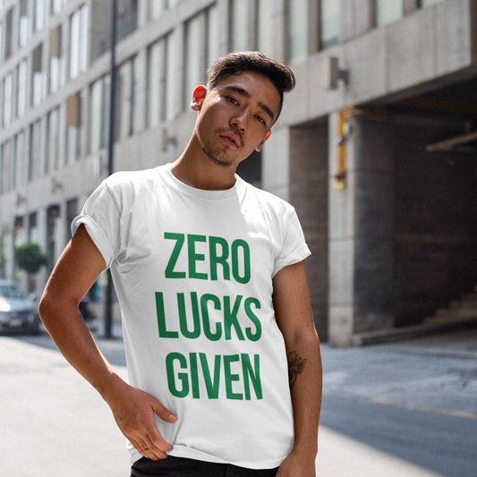 Man wearing a white t-shirt with 'ZERO LUCKS GIVEN' text in green on a city street.