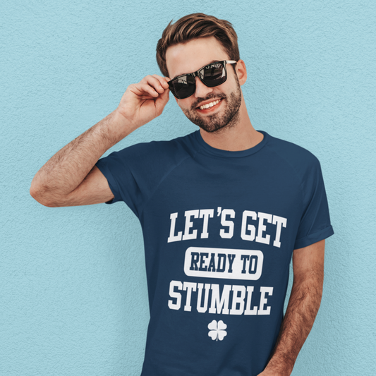 Man wearing a navy blue t-shirt with 'LET'S GET READY TO STUMBLE' text on a light blue background