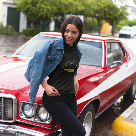 Woman leaning against a red car with white stripes in an urban setting