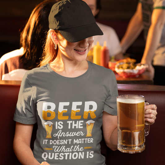 Person wearing a t-shirt with a humorous beer-themed design, holding a mug of beer in a casual setting.