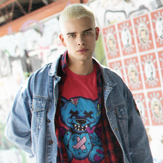 Person wearing a red t-shirt with a graphic design and a denim jacket in an urban setting.