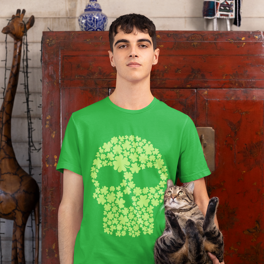 Person wearing a green t-shirt with a skull design holding a cat, standing against a wooden background.