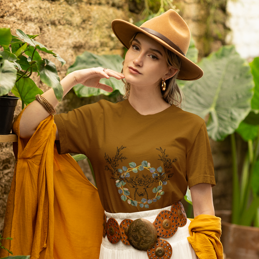 Woman wearing a brown top with a floral design, white skirt, and yellow cardigan in an outdoor setting.