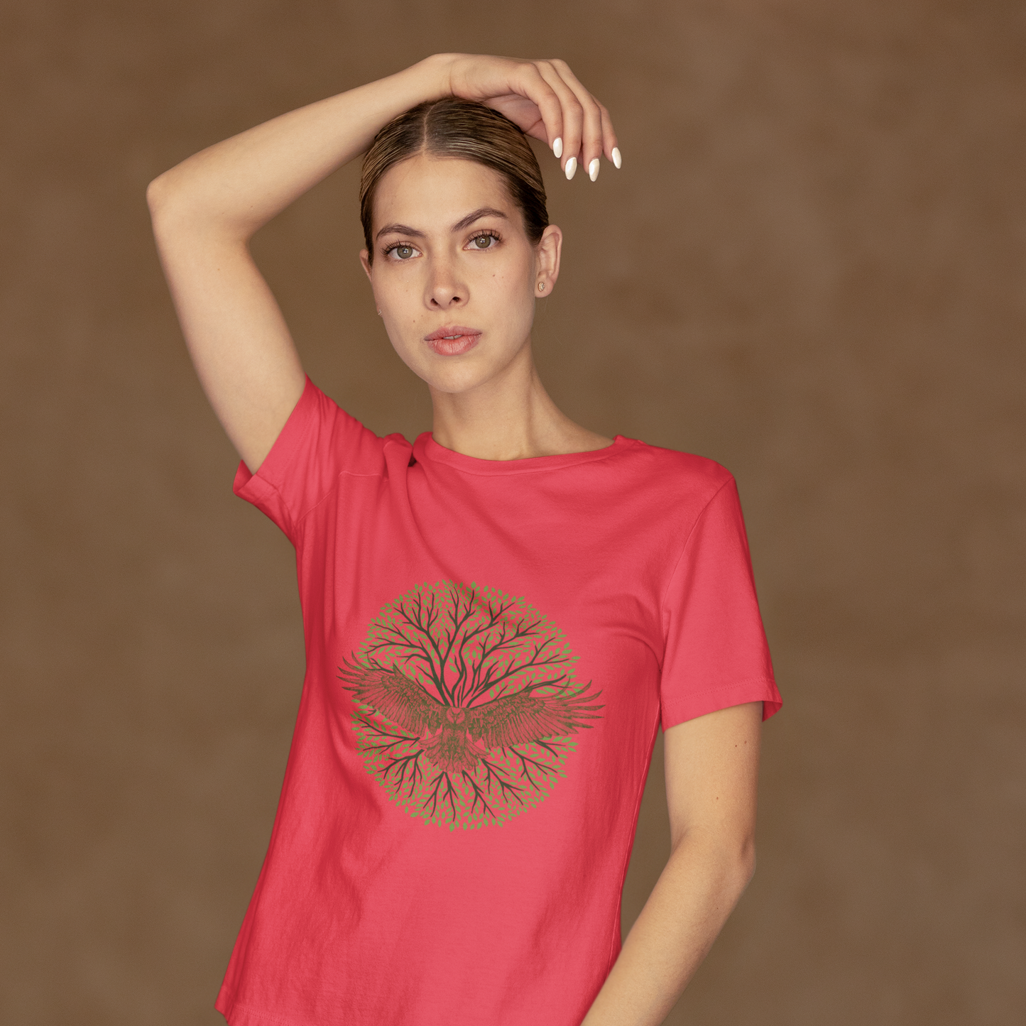 Woman wearing a red t-shirt with a graphic design on a brown background