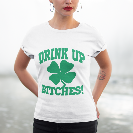 Person wearing a white t-shirt with green text and a shamrock graphic.