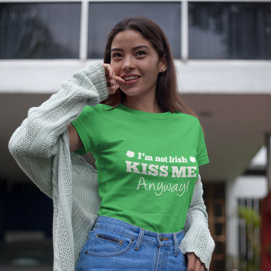 Woman wearing a green t-shirt with text, standing outdoors.