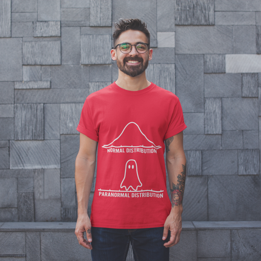 Man wearing a red t-shirt with a graphic design against a gray brick wall.