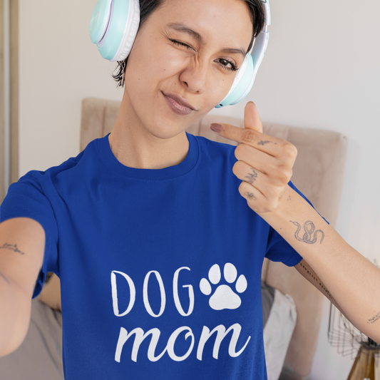Person wearing a blue 'DOG mom' t-shirt with headphones, giving a thumbs-up.