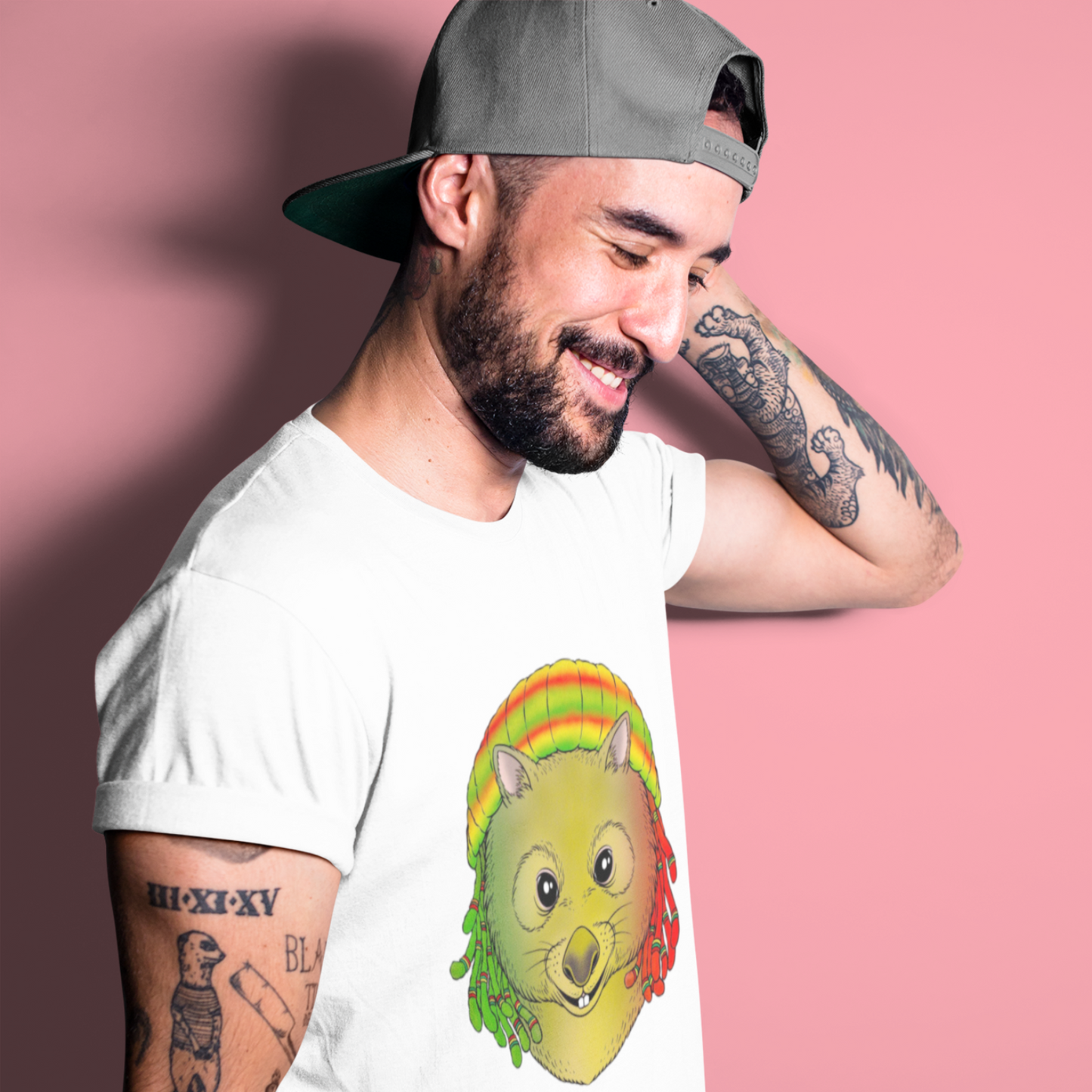 Man wearing a white t-shirt with a graphic design of a mouse in a taco on a pink background