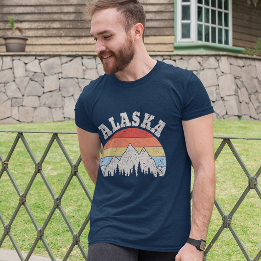 Man wearing a navy blue t-shirt with 'Alaska' design outdoors.