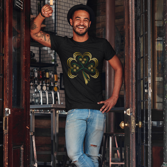 Man wearing a black t-shirt with a shamrock design, standing in a bar.