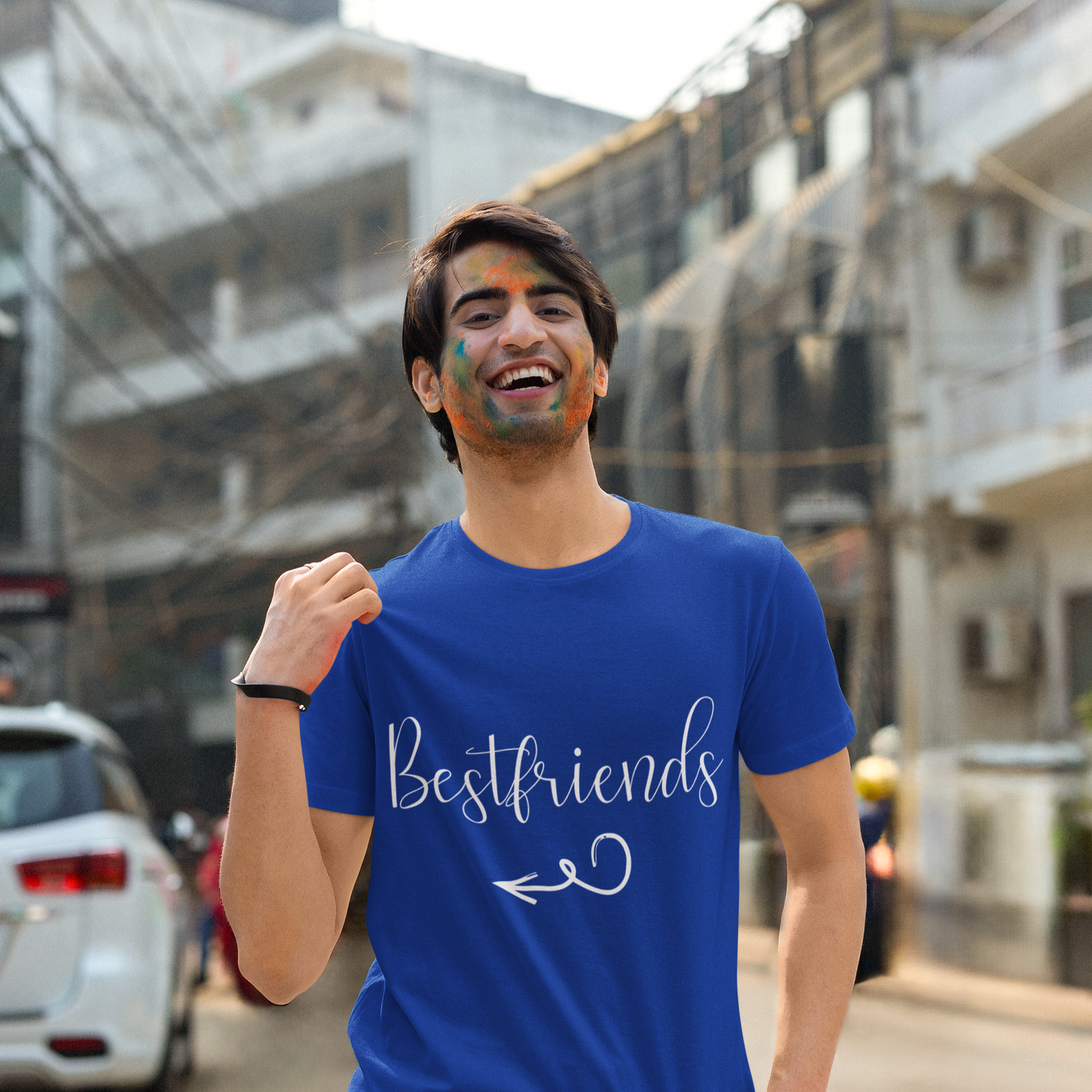 Man wearing a blue 'Bestfriends' t-shirt on a street background