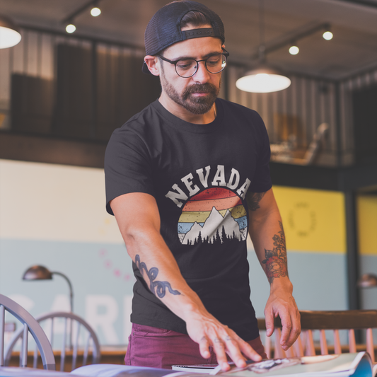 Man wearing a black t-shirt with 'NEVADA' design in a casual setting