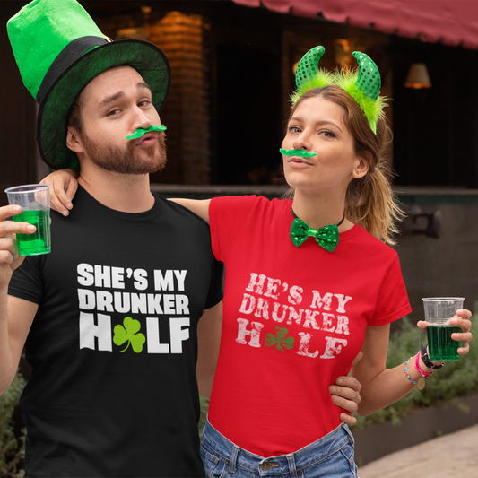 Two people wearing festive St. Patrick's Day attire with drinks, standing outdoors.