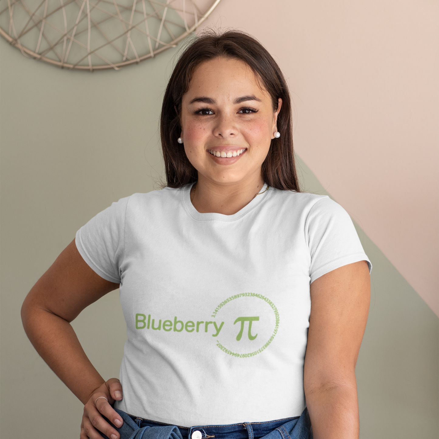 Woman wearing a white t-shirt with 'Blueberry Pi' logo, standing against a neutral wall.