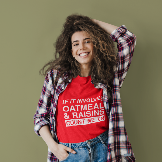 Woman wearing a red t-shirt with text and a plaid shirt over it on a green background