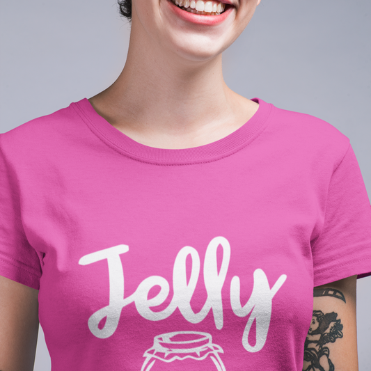 Person wearing a pink t-shirt with 'Jelly' printed on it against a gray background