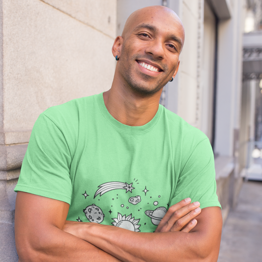 Man wearing a green t-shirt with a graphic design, standing against a building.