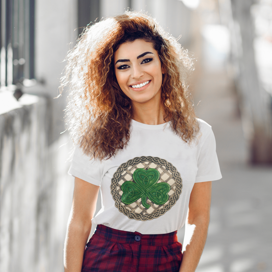 Woman wearing a white t-shirt with a shamrock design outdoors