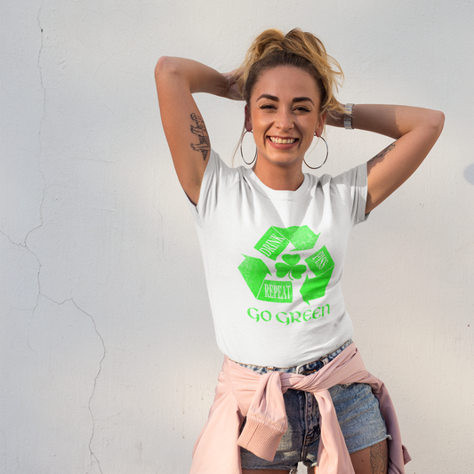 Woman wearing a white t-shirt with a green recycling symbol and text, standing against a light gray background.
