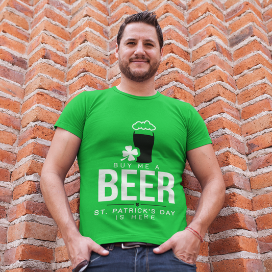 Man wearing a green St. Patrick's Day t-shirt with text and graphics against a brick wall.