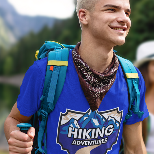 Person wearing a blue 'Hiking Adventures' shirt with a backpack and hiking gear in a natural setting.
