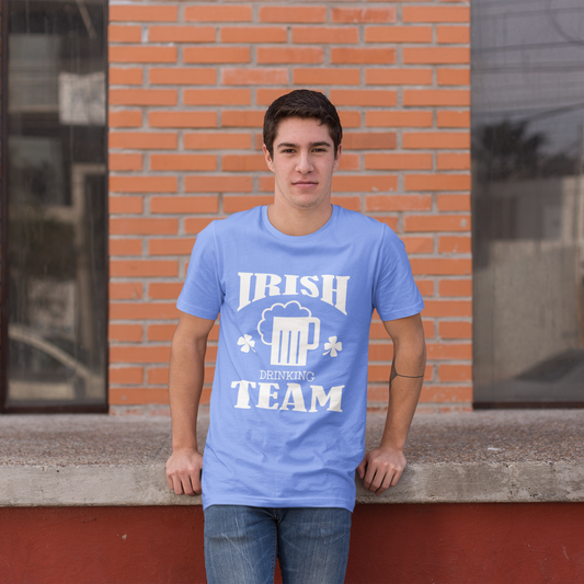 Person wearing a blue t-shirt with 'Irish Beer Team' design standing in front of a brick building.