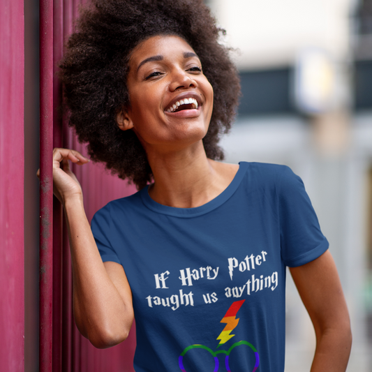 Woman wearing a blue t-shirt with a Harry Potter-themed message, leaning against a red wall.