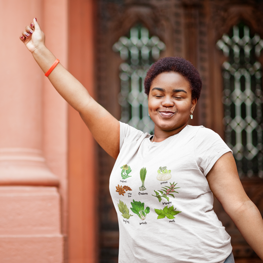 Woman wearing a white t-shirt with plant illustrations in front of a decorative wall.