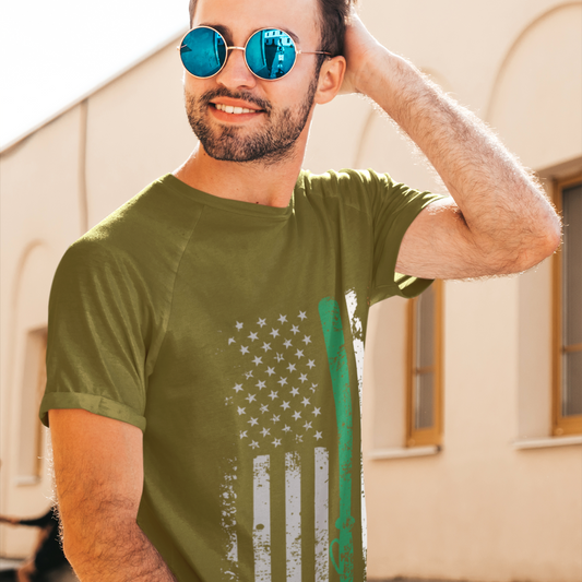 Man wearing a green t-shirt with an American flag design outdoors.