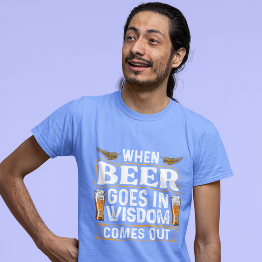 Man wearing a light blue t-shirt with a humorous print on a solid background