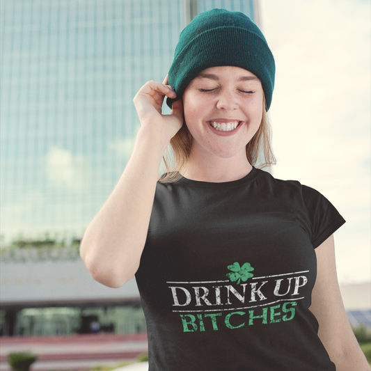 Person wearing a black t-shirt with 'DRINK UP BITCHES' text, standing outdoors.