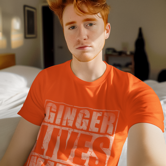 Person wearing an orange t-shirt with 'GINGER LIVES MATTER' text in a bedroom setting.