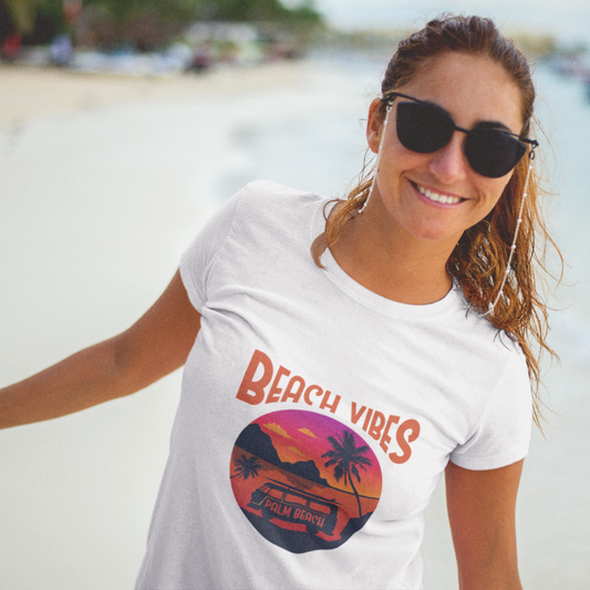 Woman wearing a 'Beach Vibes' t-shirt on a beach