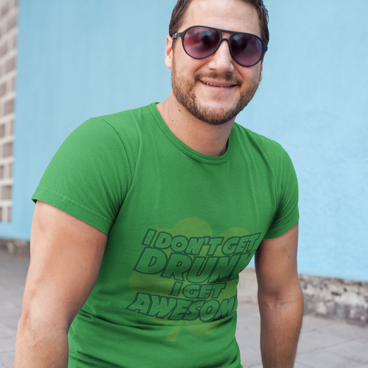 Man wearing a green t-shirt with humorous text against a light blue wall.
