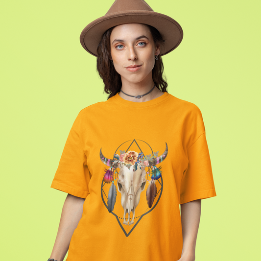 Woman wearing an orange t-shirt with a bull skull design on a green background