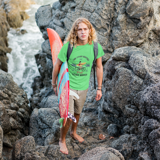 Man with a surfboard standing on rocky terrain near water