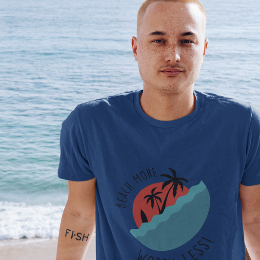 Man wearing a blue t-shirt with a graphic design by the ocean