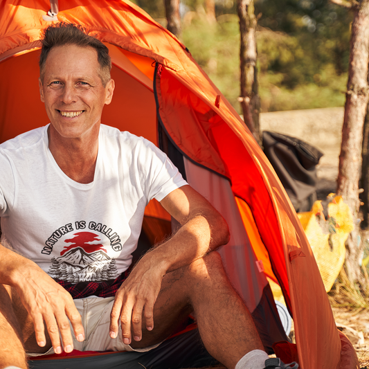 Man sitting inside an orange tent with a scenic outdoor background