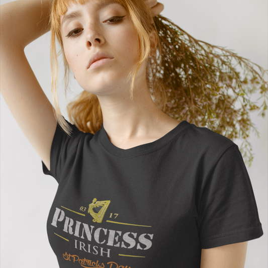 Woman wearing a black t-shirt with 'Princess Irish' text, standing against a light background.