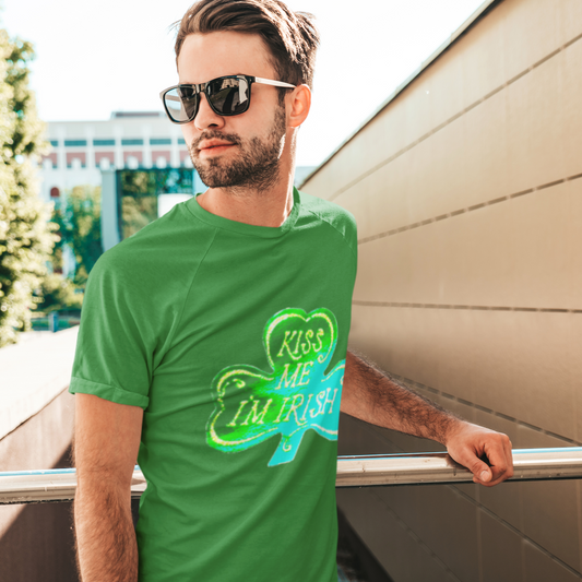 Man wearing a green t-shirt with 'Kiss Me I'm Irish' design outdoors.