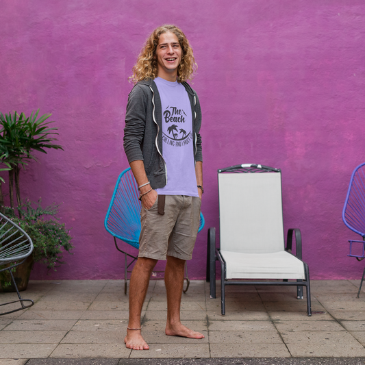 Person standing in front of a purple wall with decorative chairs and plants.
