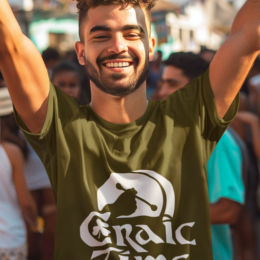 Man wearing a green 'Graic Time' t-shirt with arms raised in an outdoor setting
