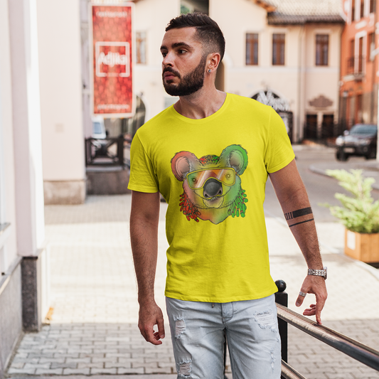 Man wearing a bright yellow t-shirt with a colorful bear graphic on a city street.