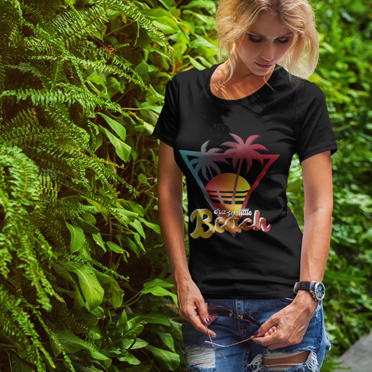 Woman wearing a black t-shirt with a colorful graphic design, standing against a green leafy background.