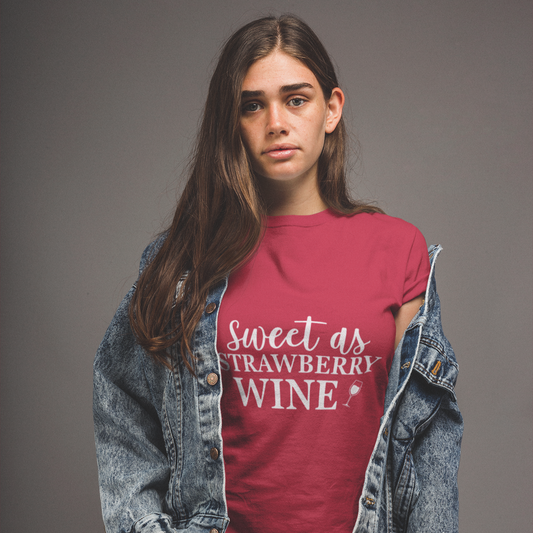 Person wearing a red t-shirt with 'Sweet as Strawberry Wine' text, standing against a gray background